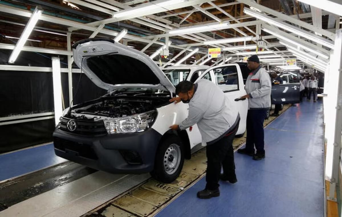 Workers check a vehicle coming off the production line at Toyota’s South Africa Motors plant in Durban, South Africa